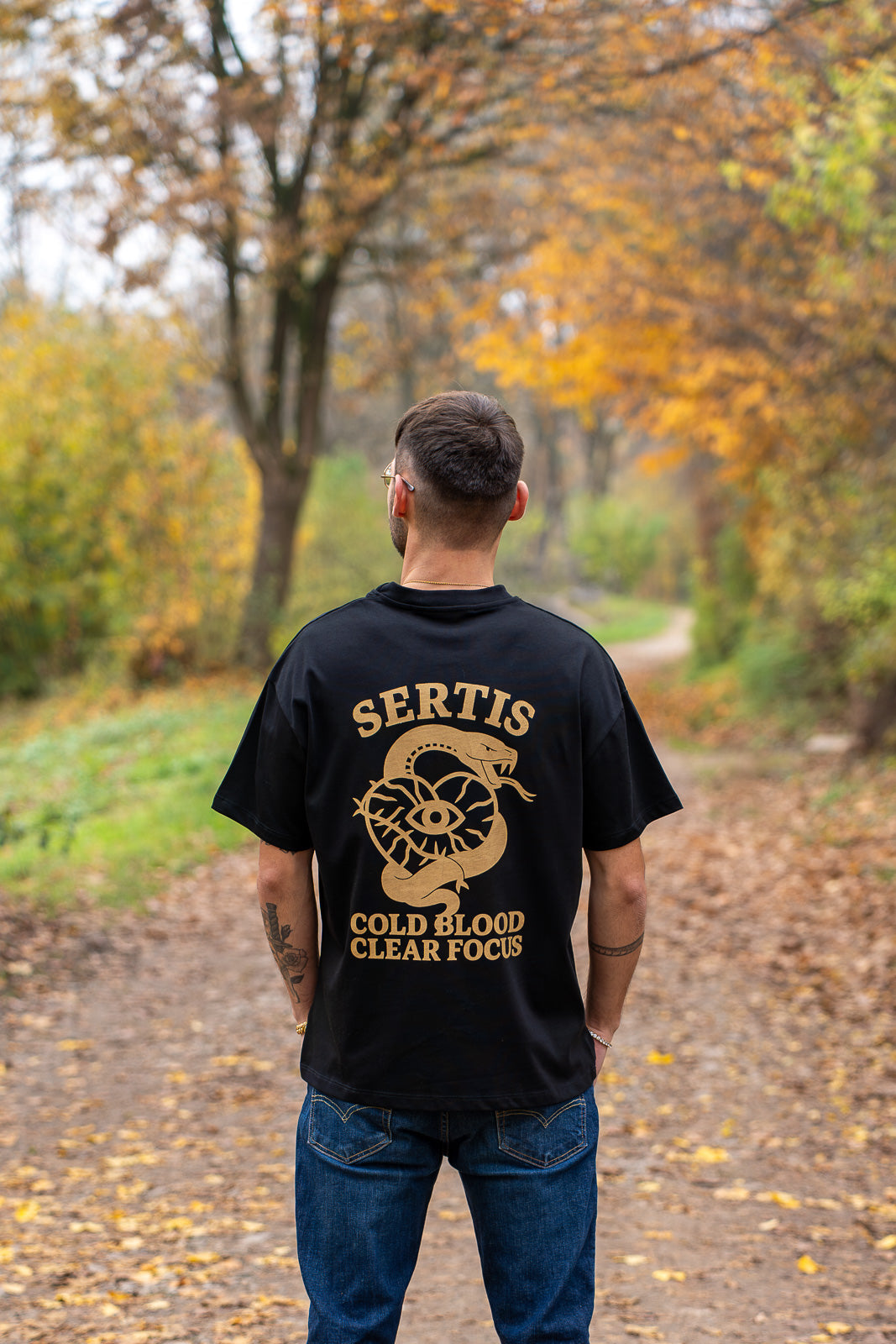 Black and gold Snake Tee worn, back view